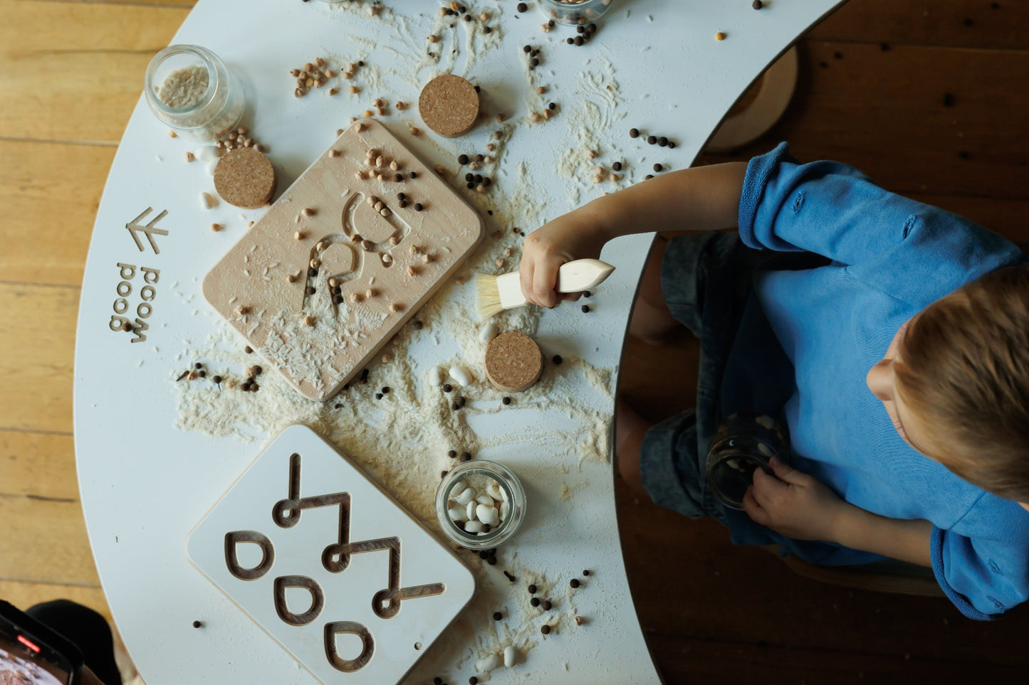 a boy playing good wood preschool wooden board