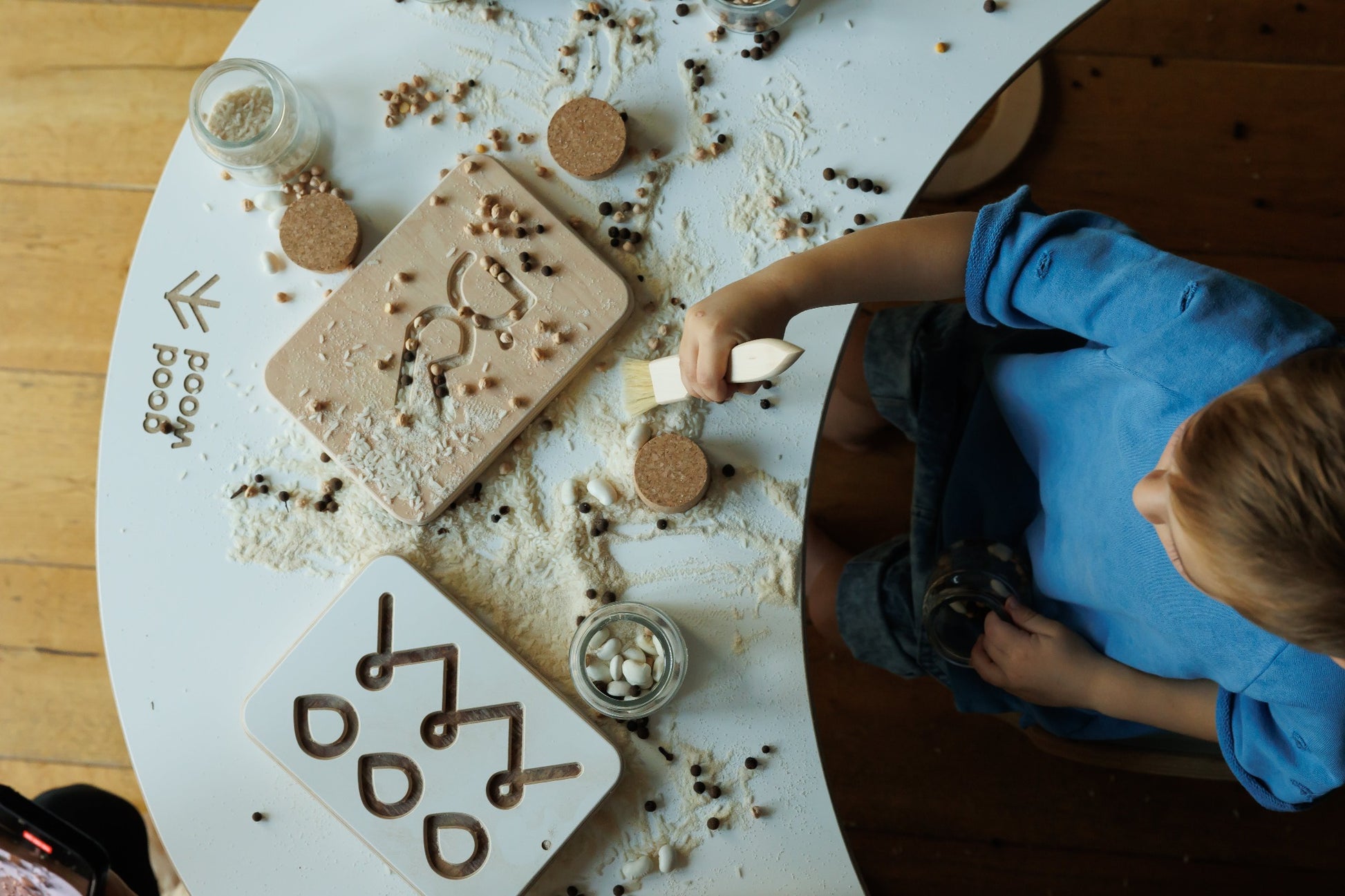 a boy playing good wood preschool wooden board