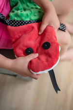 a girl squeezing a head of tactile sensory snake