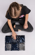 Laden Sie das Bild in den Galerie-Viewer, girl sitting with Two tone sequin weighted lap pillow in black and silver
